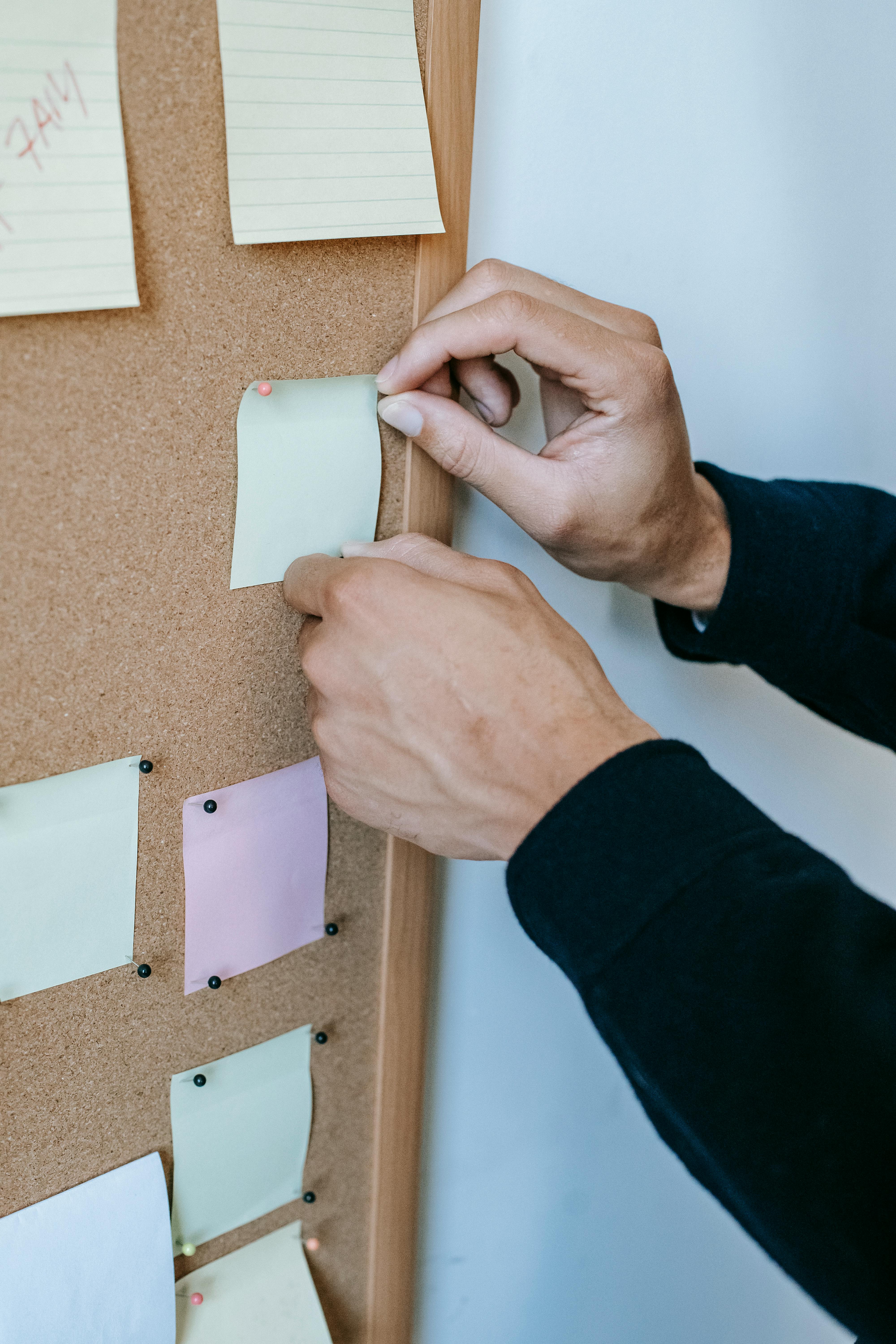 A picture of a noticeboard with some sticky notes pinned